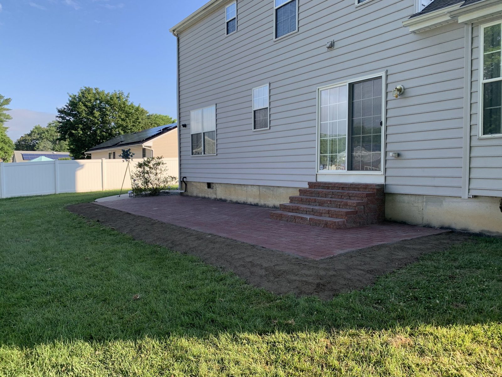Paver pool patio surrounded by landscaping