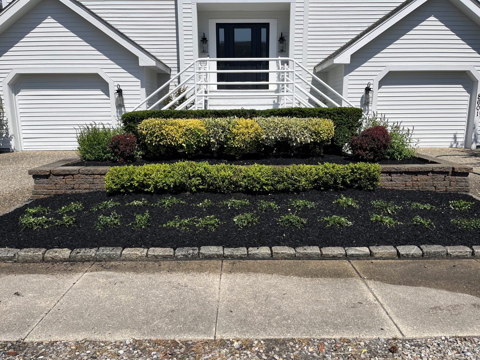 Decorative stone bed with trimmed shrubs
